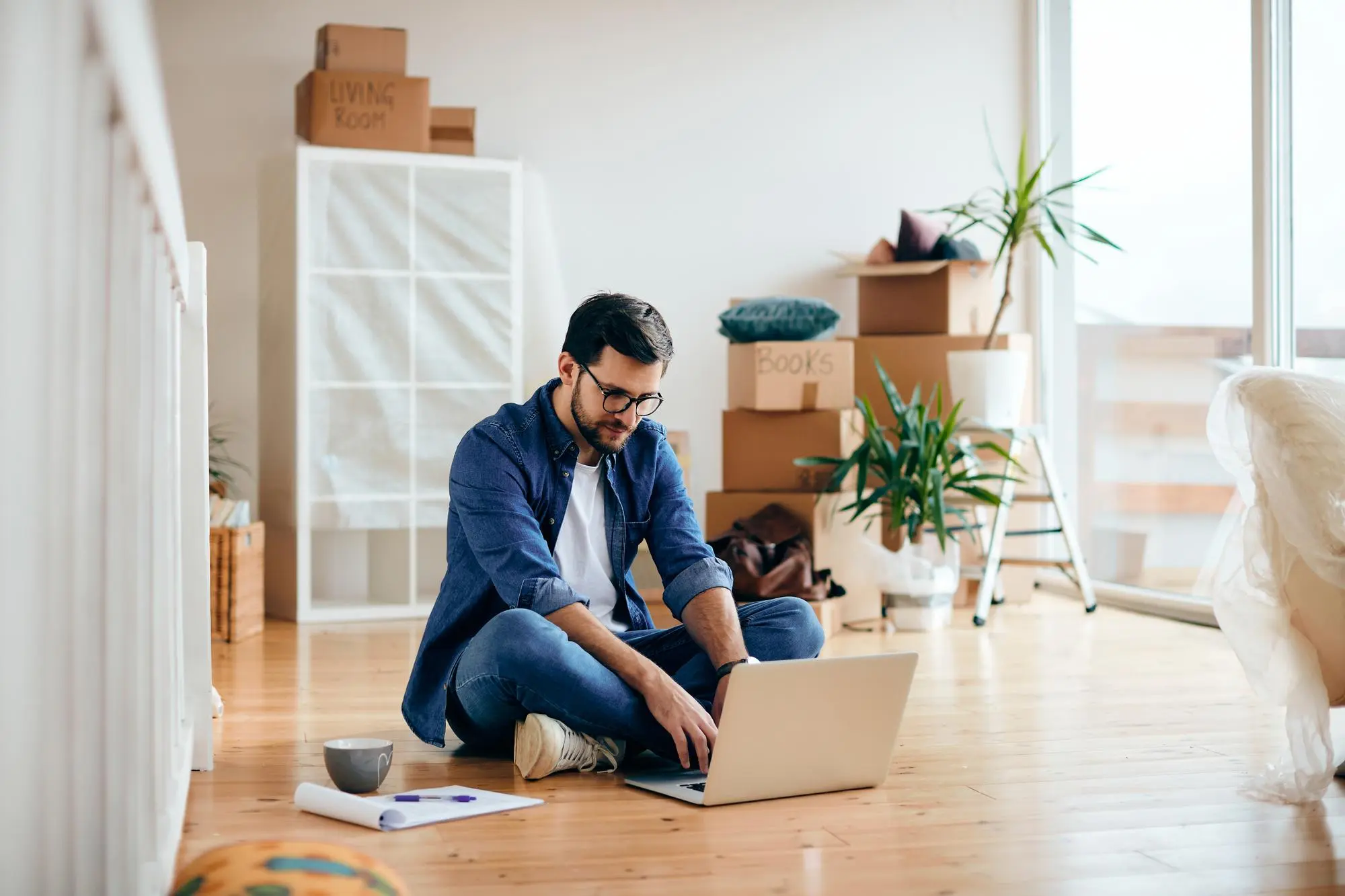 Homeowner budgeting for a 500 sq ft ADU construction cost on a laptop in a new home – TG Renovations