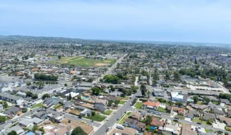 Aerial view of residential streets and suburban homes in Whittier California under a clear blue sky tg renovations